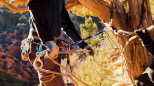 a person holding rappelling gear