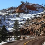 The canyons of Zion National Park during the winter speckled with snow while the trees still appear from the snowfall