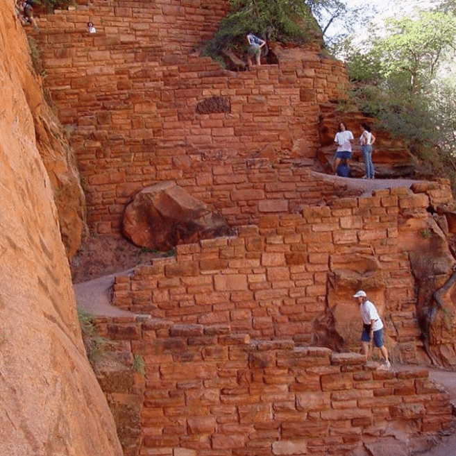 hikers on walter's wiggles section of zion national park's angels landing trail
