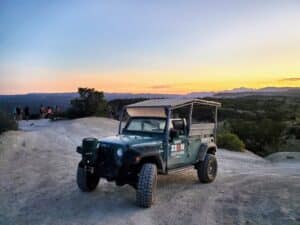 a truck driving down a dirt road