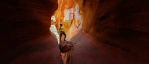 A person standing in a slot canyon