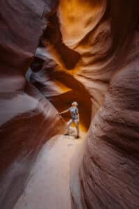 23 Zion Adventures for 2023 16 A person gazing in awe inside a slot canyon