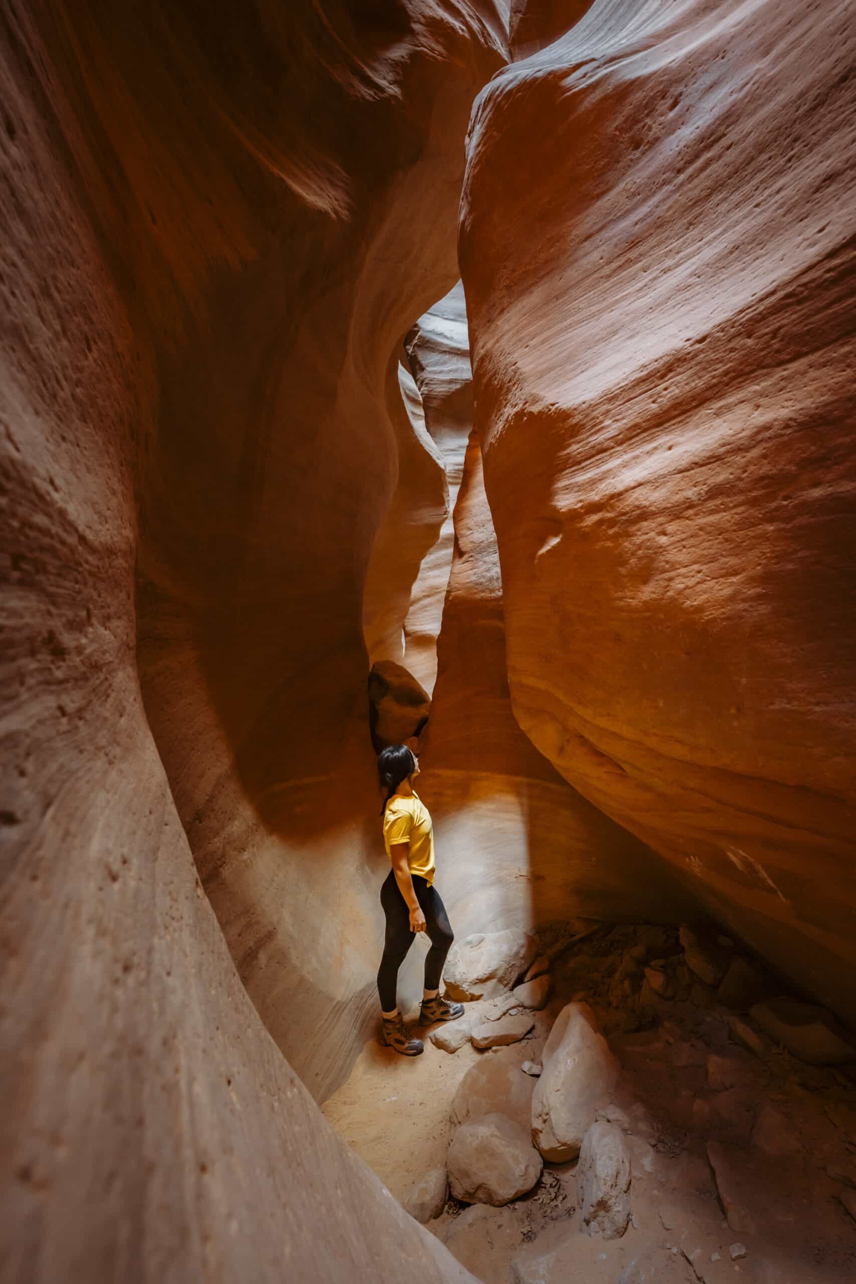 A person gazing in awe in a red rock slot canyon