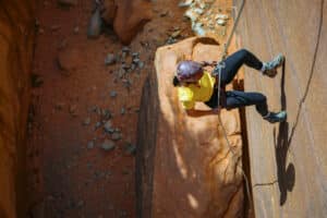 23 Zion Adventures for 2023 11 A person rappelling in an East Zion slot canyon