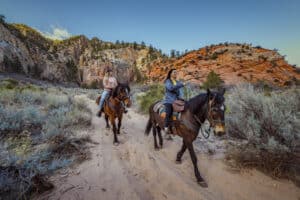 People riding horseback in an East Zion canyon