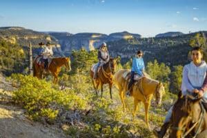 people riding horses in east zion