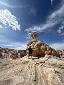 A man hiking the Vermillion Cliffs White Pocket guided hiking tour