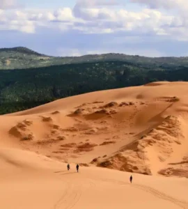 People walking on Coral Pink sand dunes